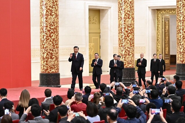 10月23日，刚刚在中国共产党第二十届中央委员会第一次全体会议上当选的中共中央总书记习近平和中共中央政治局常委李强、赵乐际、王沪宁、蔡奇、丁薛祥、李希在北京人民大会堂同采访中共二十大的中外记者亲切见面。这是习近平等在热烈的掌声中步入大厅。新华社记者 翟健岚 摄